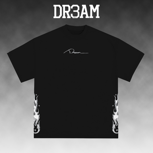 A black short-sleeve t-shirt with a white script logo on the chest and white flame graphics on both lower sides, displayed against a gray gradient background with 'DR3AM' text at the top.