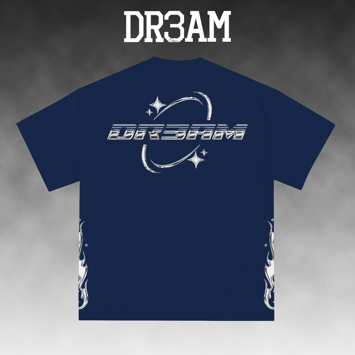A navy blue t-shirt with a white graphic print on the front featuring stylized text and stars, displayed against a gray gradient background with the text 'DR3AM' at the top.