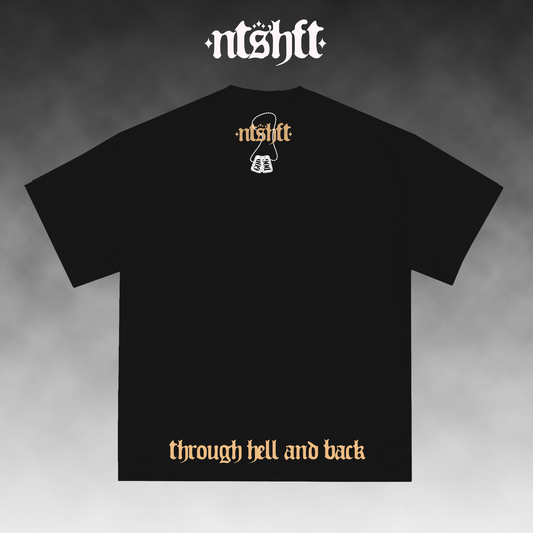 Black short-sleeve t-shirt shown from the back on a smoky gray gradient background. The shirt features a small white graphic and the word 'ntshft' in orange-gold near the upper back, with the phrase 'through hell and back' printed in the same orange-gold font near the lower hem.