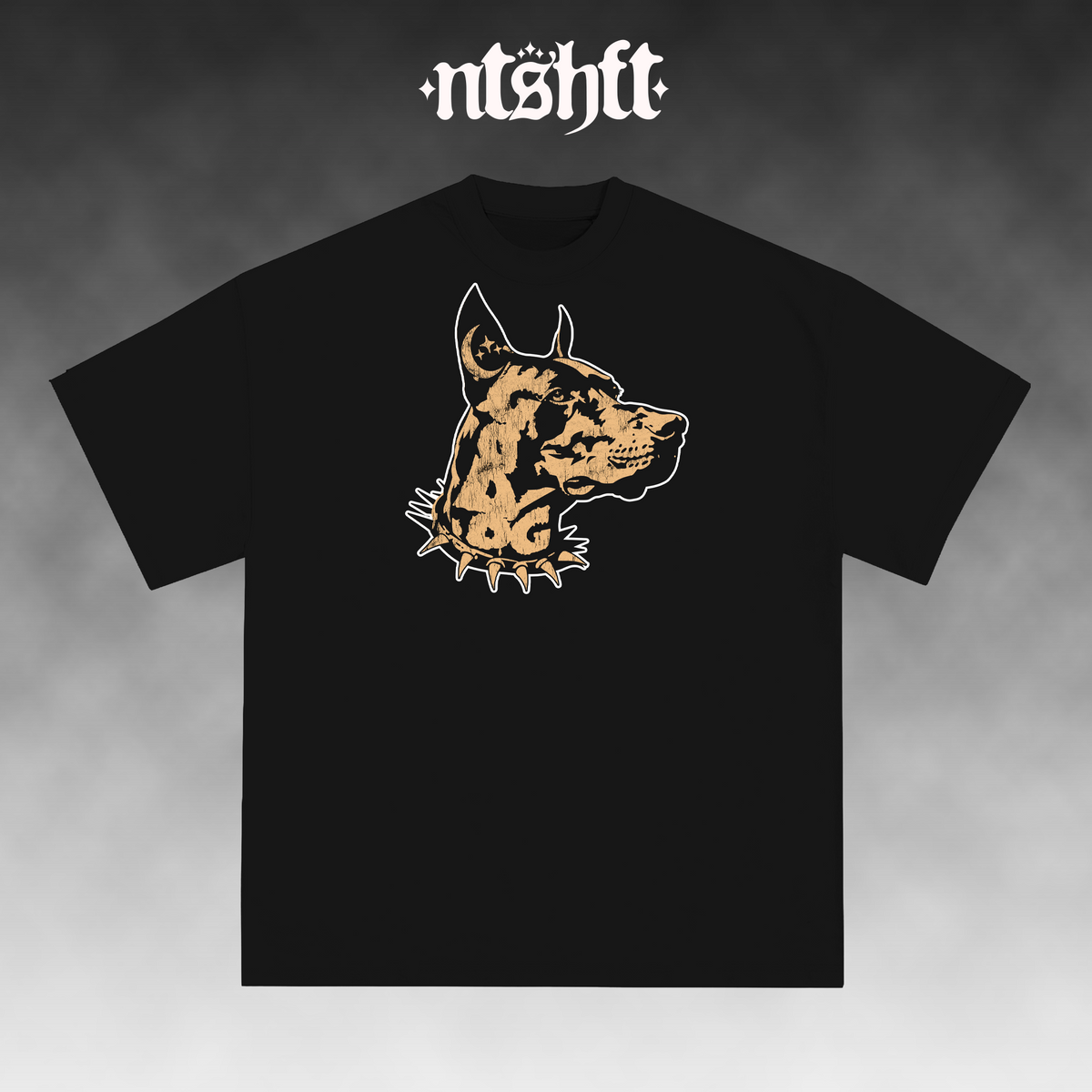 A black short-sleeve t-shirt with a stylized graphic of a dog's head in tan and white on the chest. The brand name 'ntshft' is printed in a white gothic font at the top of the image, set against a dark gray gradient background.